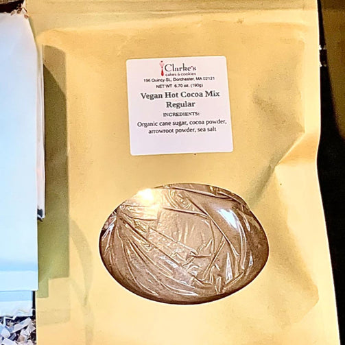 Vegan hot cocoa mix package with a label on a wooden surface